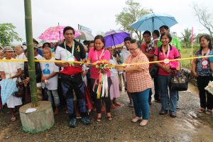 Director Remia T. Tapispisan (in peach shirt)  leads the ribbon cutting for the inauguration of the core shelter units. Joining her are Vice Mayor Taberner (1st from left), Mayor Lycelle D. Vicente (2nd from left) and Ms. Lucy Alan, DSWD FO 02 Head of Protective Services Unit (back row, in pink shirt)